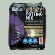 A 15-liter bag of Bruggings Ultimate Potting Mix, featuring a black background with a large purple flower graphic and gold and white text, placed on a light-colored tiled floor.